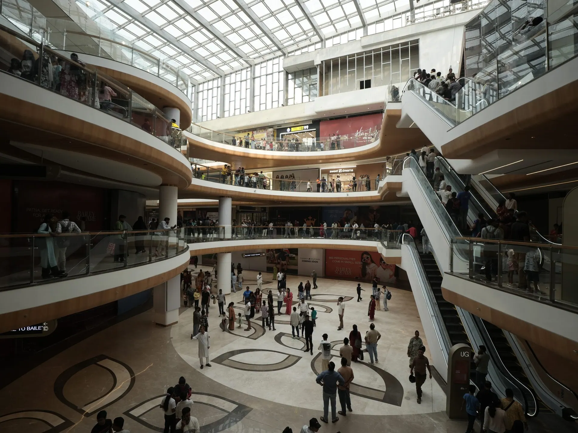 Curved balconies around the atrium void at Bailey Square, Patna